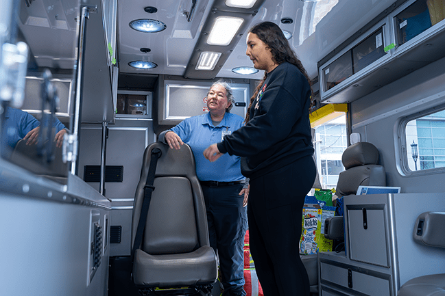 Student talking with emt inside an ambulance