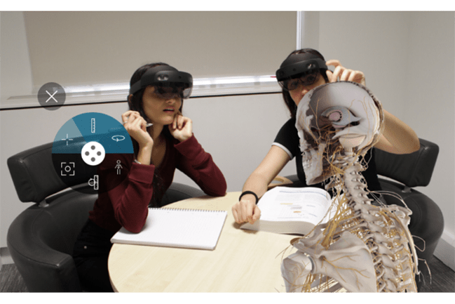 Student using augmented reality to study a virtual human skeleton