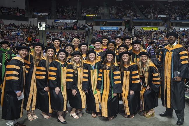 Large group of graduates posing for photo at Commencement