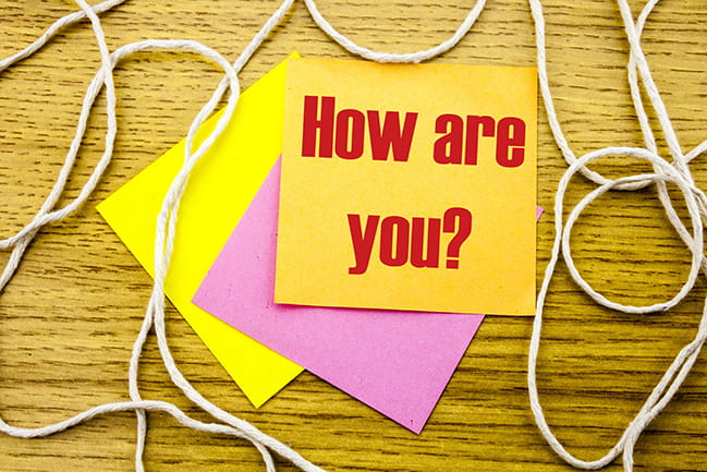 How are you? typed on yellow Post-it note