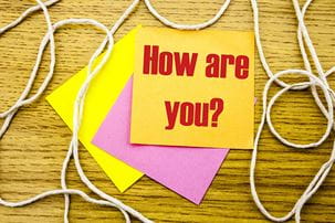 How are you? typed on yellow Post-it note