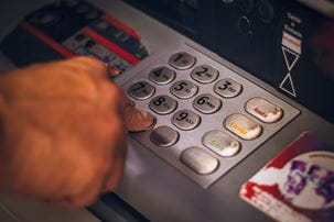 Man pushing ATM buttons