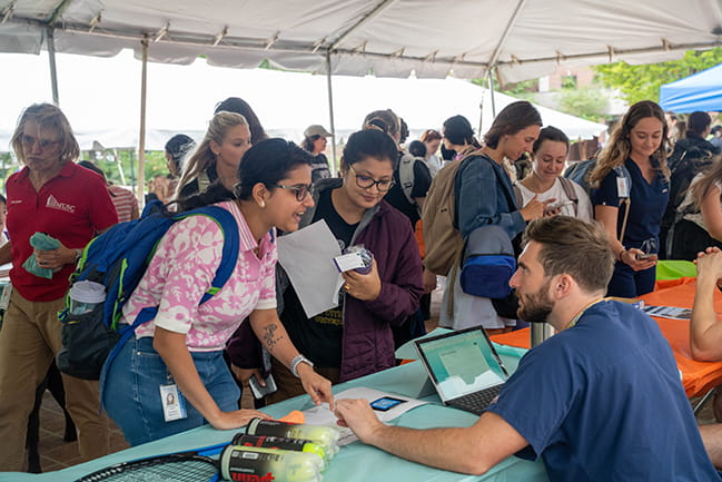 Students talking at a table at the Activities Fair