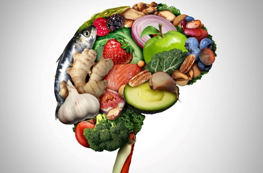 Healthy brain food to boost brainpower nutrition concept as a group of nutritious nuts fish vegetables and berries rich in omega-3 fatty acids for mind health as a composite image.