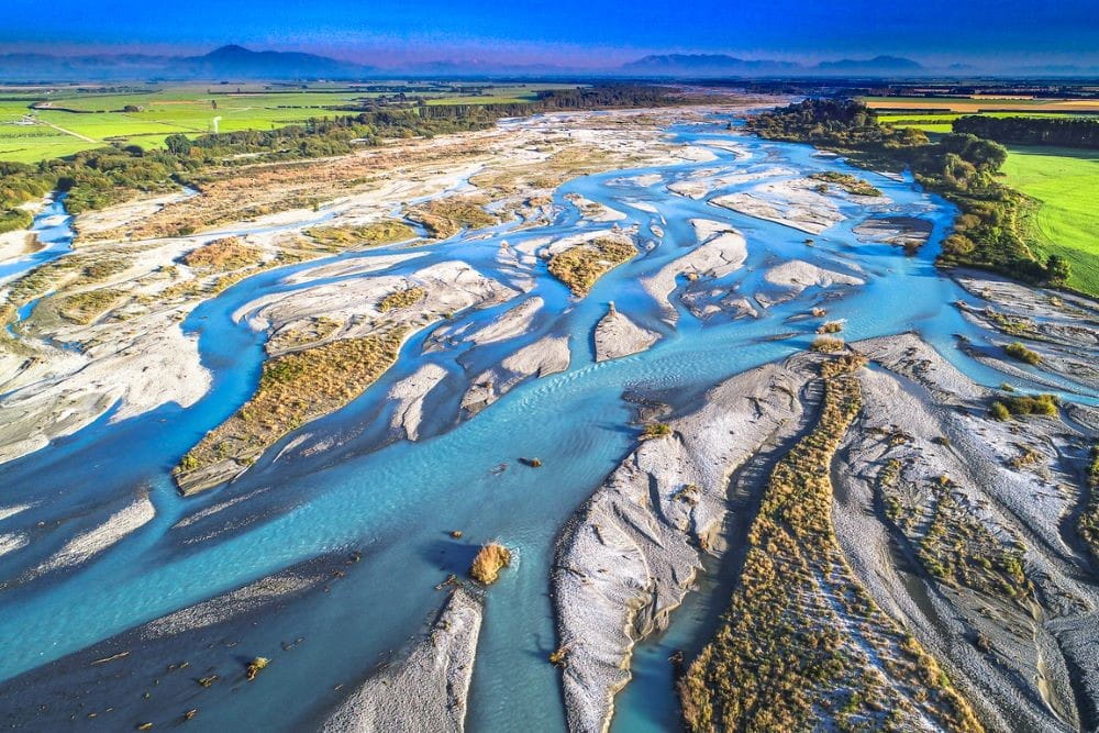 This river is one of the largest braided rivers in New Zealand with a flow of 203 cubic metres per second, running from the mountains to the Pacific Ocean.