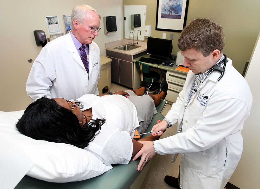 Dr. William Moran, left, works with resident Dr. Lance McLeroy in 2017. Photo by Sarah Pack 