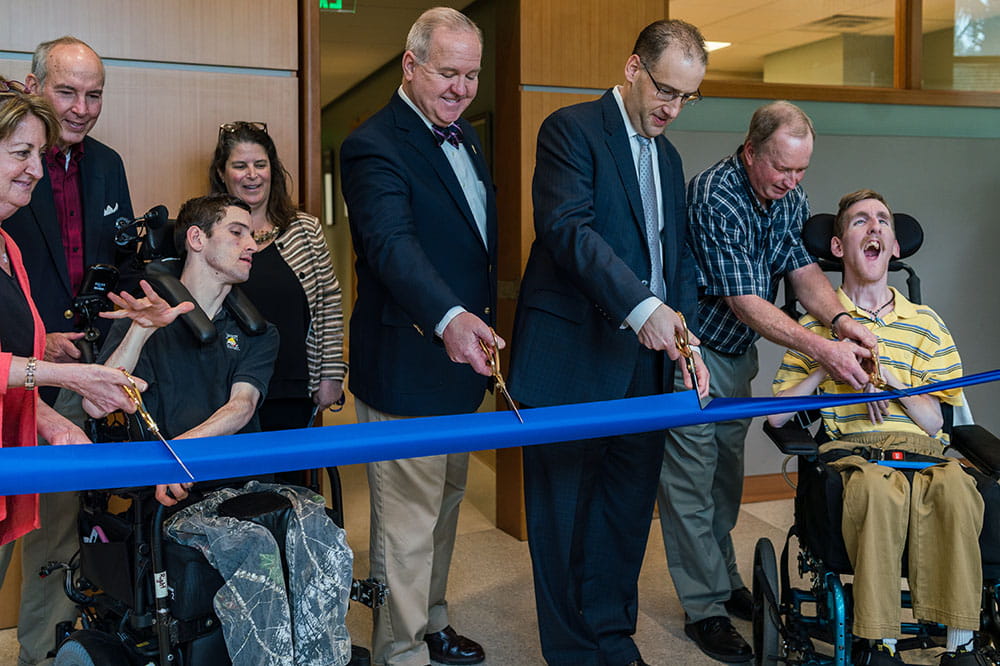 Patients Andrew Stubbs and William Ray are among ribbon cutters at special needs clinic