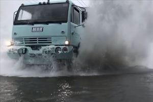 truck driving through flood waters
