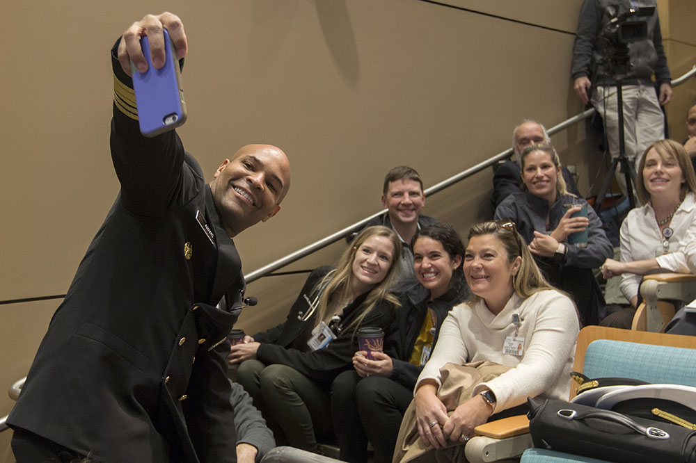 Dr. Jerome Adams takes a selfie with audience members