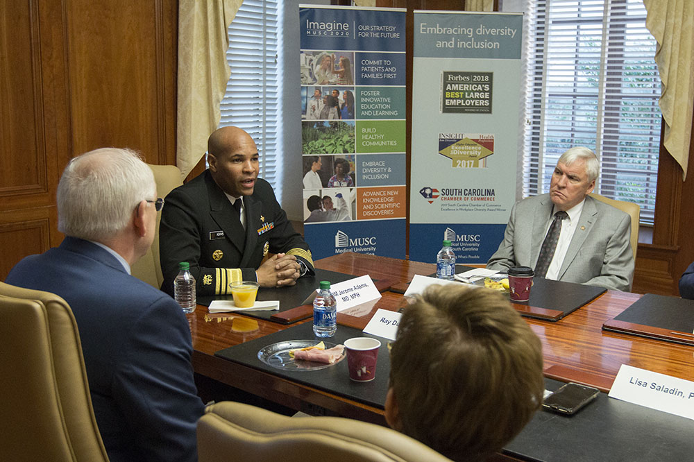 U.S. Surgeon General Jerome Adams talks with Dr. Ray DuBois and Dr. David Cole and others