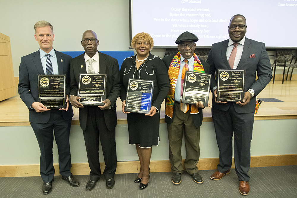 group photo of honorees holding their plaques