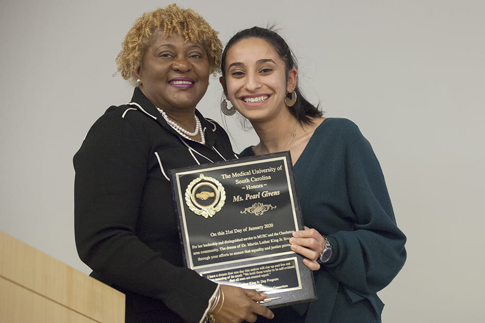 Pearl Givens and Mirna Rezkalla post with Givens' plaque