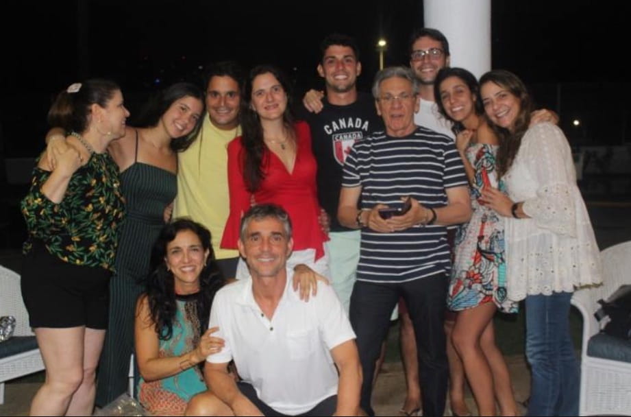 Victor Araujo with his large family on a veranda at night.
