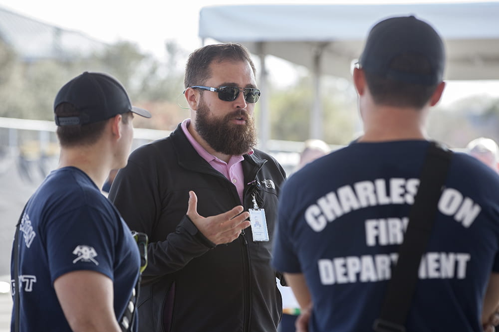 two firefighters talk to an MUSC emergency manager outdoors