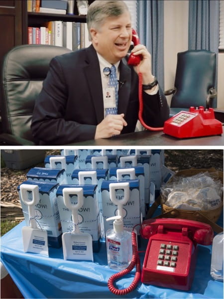 A series of two photos, one is a still image from the film with the dean talking on a red phone and the other is of a table of goodies from the event featuring plastic shovels sitting next to the red phone from the film