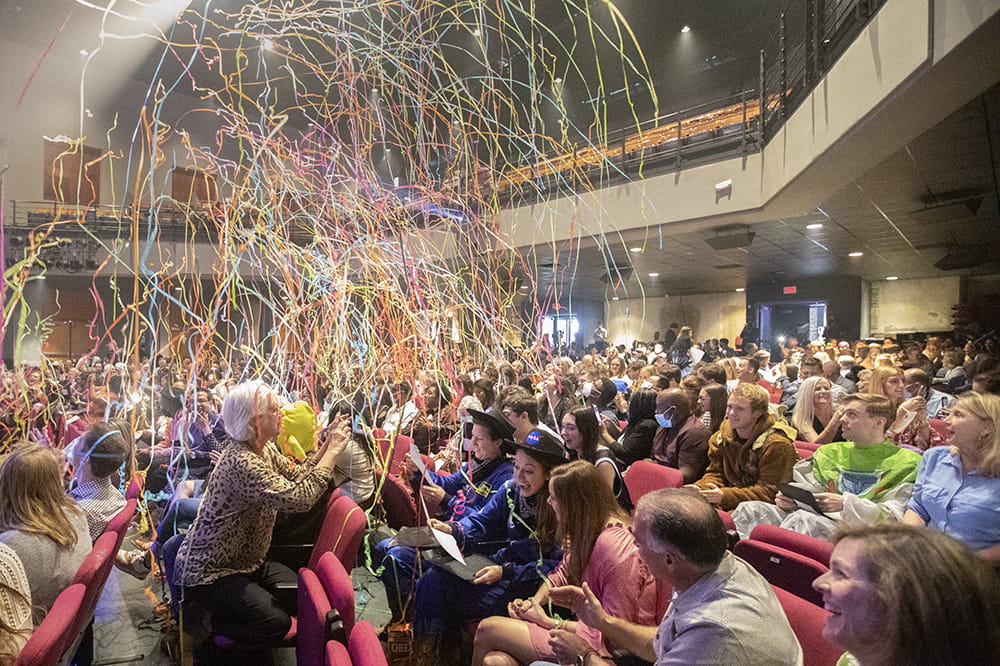 Crowd in auditorium is covered by confetti