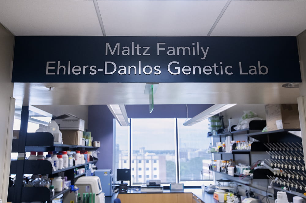A sign above the entrance to an area in the lab says Maltz Family Ehlers Danlos Genetic Lab