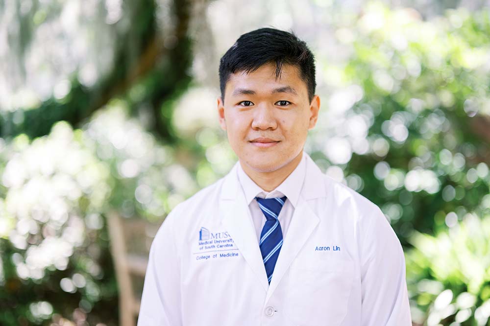 Young man in white coat wearing a blue tie